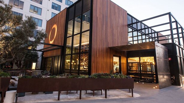 A modern building with large glass windows and a wooden facade. - New Downtown LA Luxury Jr. Penthouse (Los Angeles)