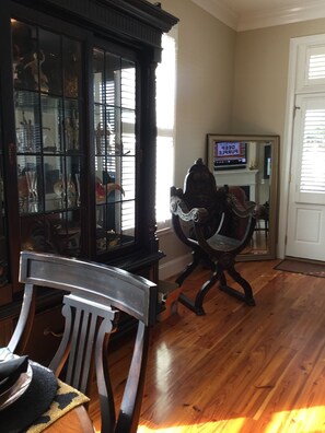 Relax in a cozy seating area with a comfortable chair and fireplace, perfect for unwinding.