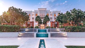 A grand hotel with a central fountain, multiple floors, and a traditional architectural style.