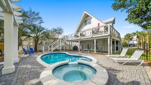 A swimming pool with a hot tub, surrounded by a patio area with lounge chairs and a covered deck. - Joanna House! Seagrove Beach Cottage, Private Pool, Spacious, close to Seaside. (Seagrove Beach)