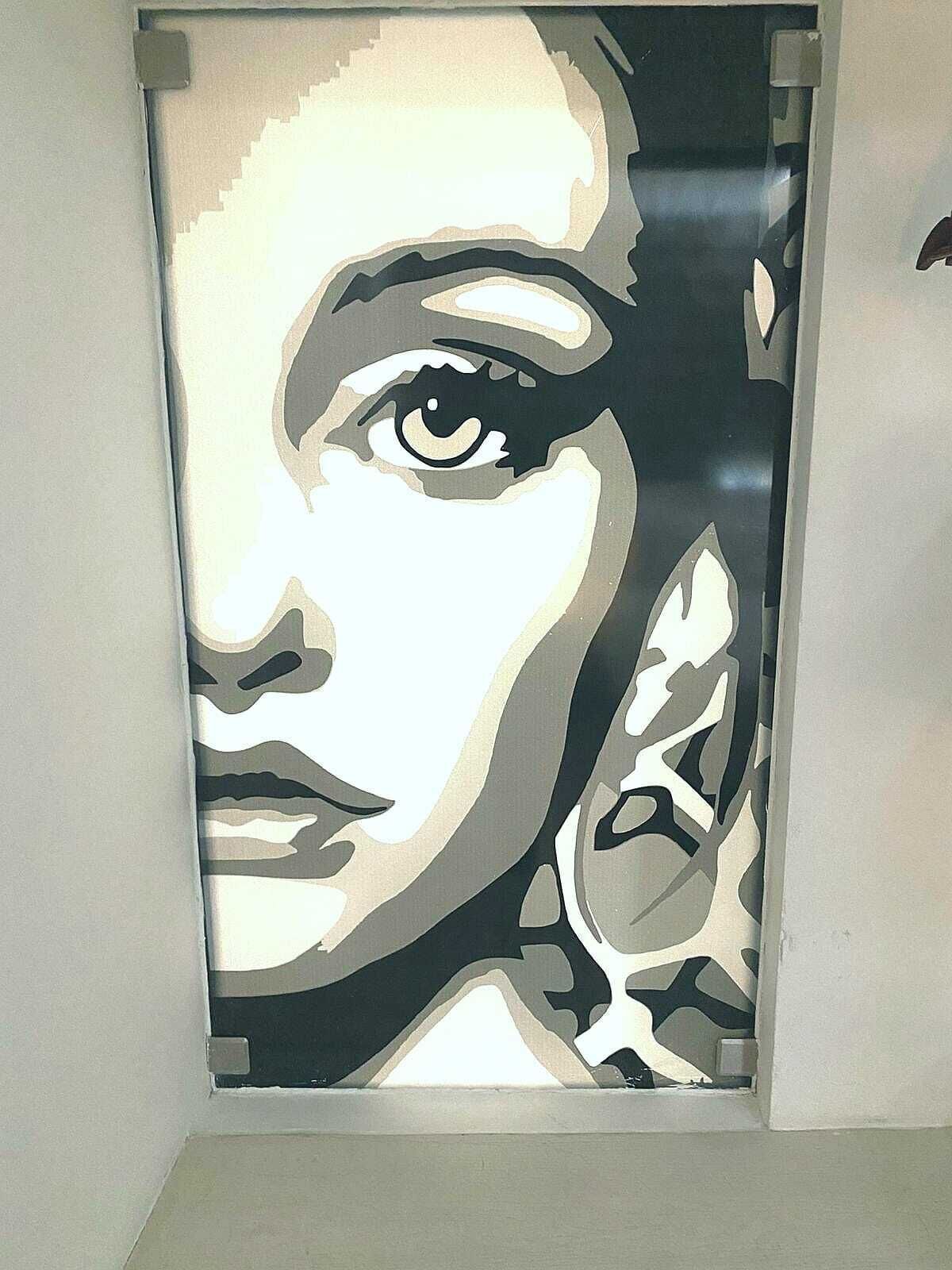 A framed artwork with a monochromatic abstract design.
