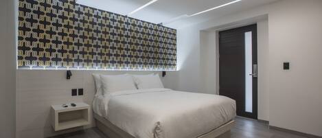 A modern bedroom with a large bed, a nightstand, a patterned wall, and a door.