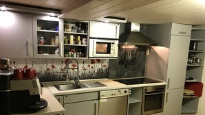 A modern kitchen with a microwave, oven, and stainless steel appliances.