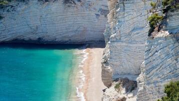 On the beach, sun-loungers