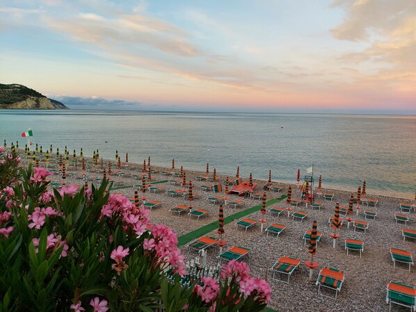 On the beach, sun-loungers