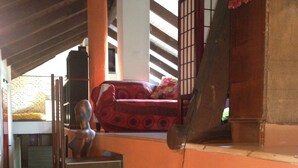 A staircase leading to a lofted bed area with a red bedspread. - JOY VILLA APARTMENT LOFT (Acqui Terme)