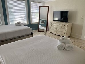 A hotel room with two beds, a TV, a dresser, and a mirror. - 2330/B Comfy 2 bed dual master with Backyard! (San Diego)