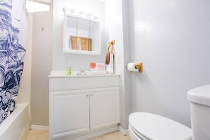 A bathroom with a white sink, mirror, and toilet. - 2330/B Comfy 2 bed dual master with Backyard! (San Diego)