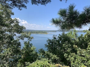 Un lago rodeado de árboles frondosos y un cielo despejado.