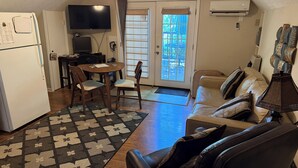 A compact living space with a kitchenette, a dining area, a sofa, and a TV. -  Activity all around!  stay up in the trees, Take in the activity or just chill
 (Glasgow)