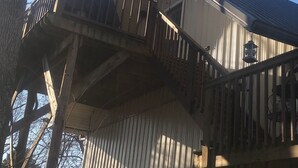A building with a metal exterior, a wooden staircase, and a balcony. -  Activity all around!  stay up in the trees, Take in the activity or just chill
 (Glasgow)
