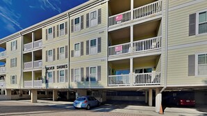 A multi-story building with balconies, a parking garage, and a storefront named "Silver Shores". - Pet-Friendly Retreat w/ Private Balcony, Just A Short Walk To The Beach (Tybee Island)