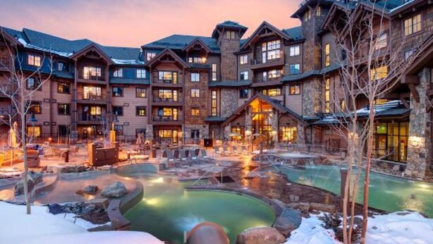 A lodge with multiple buildings, a central heated pool, and snow-covered ground. - Luxury True Ski-in/out slope side condo March 17-24, 2024 Prime Spring Break (Breckenridge)