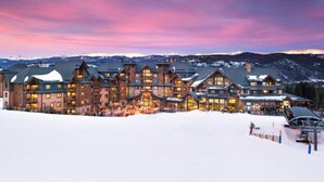 A large lodge with multiple buildings, a ski lift, and a snowy landscape. - Luxury True Ski-in/out slope side condo March 17-24, 2024 Prime Spring Break (Breckenridge)