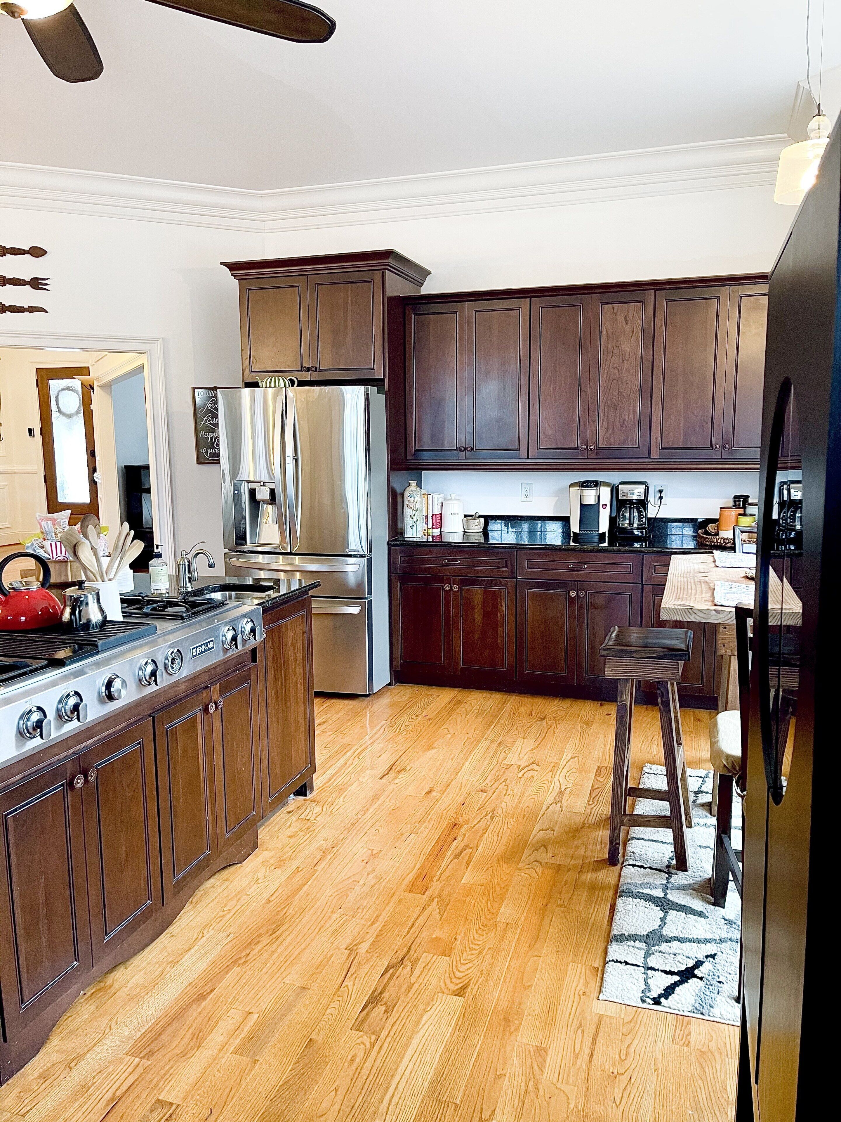 A kitchen with wooden cabinets, stainless steel appliances, and a central island.