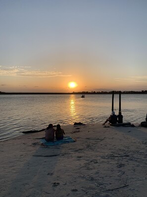 Relax on the beach with a serene view of the ocean, perfect for a romantic getaway.