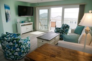 Relax in a comfortable living area with a floral-patterned sofa and armchair, perfect for socializing or unwinding.