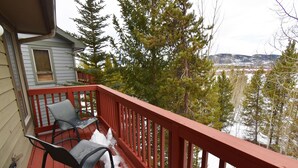 A wooden deck with a red railing, two chairs, and a small table. - Big End Unit, Deck! Near Lake Trail. Easy Drive to Dining, Activities, Events (Frisco)