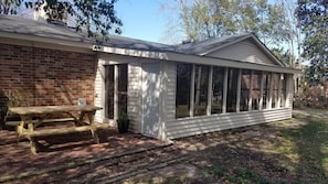Enjoy outdoor dining or relaxation on the covered porch with unobstructed views of the surrounding area.