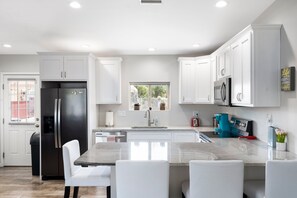Enjoy cooking in this well-lit kitchen with a central island and modern appliances.