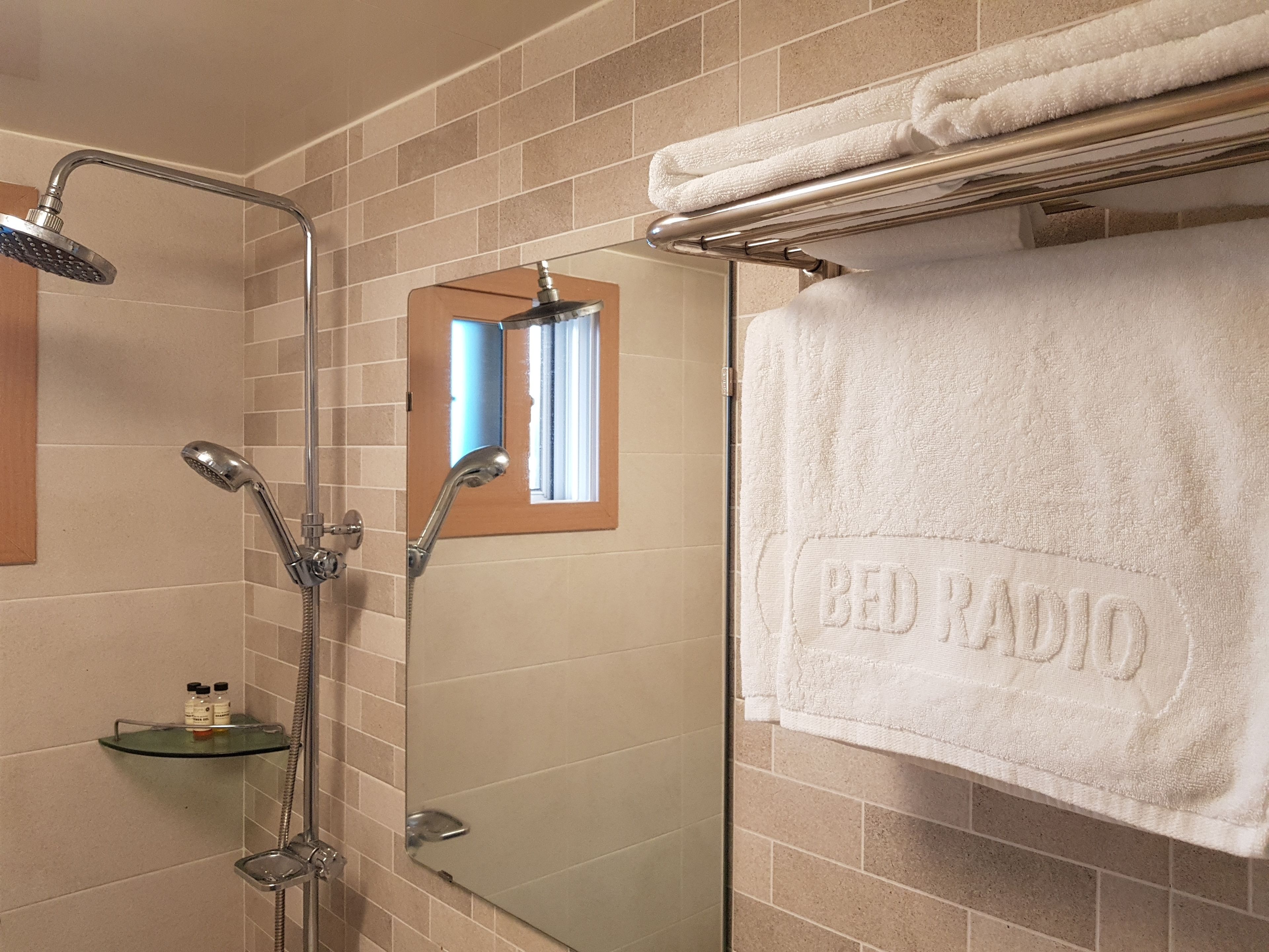 Shower, hair dryer, slippers, towels