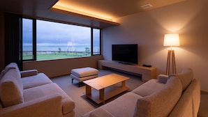 A modern living room with a large window, a flat-screen TV, a lamp, and a sofa. - Imigre (Himi)