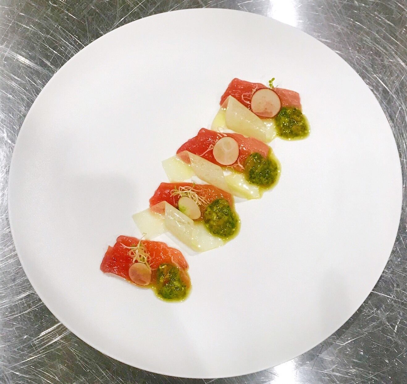 A white plate with a food arrangement.