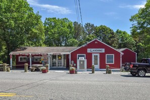 A red building with a sign reading "The Landing" and a truck parked in front.