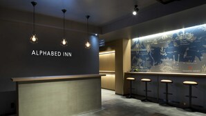 A reception area with a counter, bar stools, and a wall map.