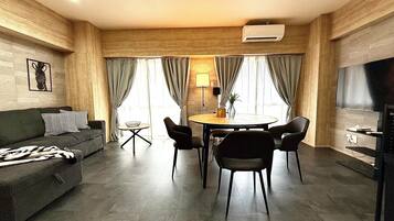 Superior Apartment | Living area | 50-inch flat-screen TV with digital channels, TV, tablet