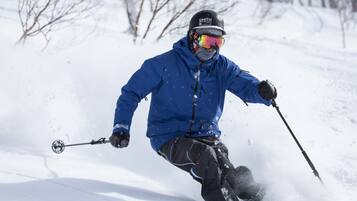 A person skiing down a snowy slope.