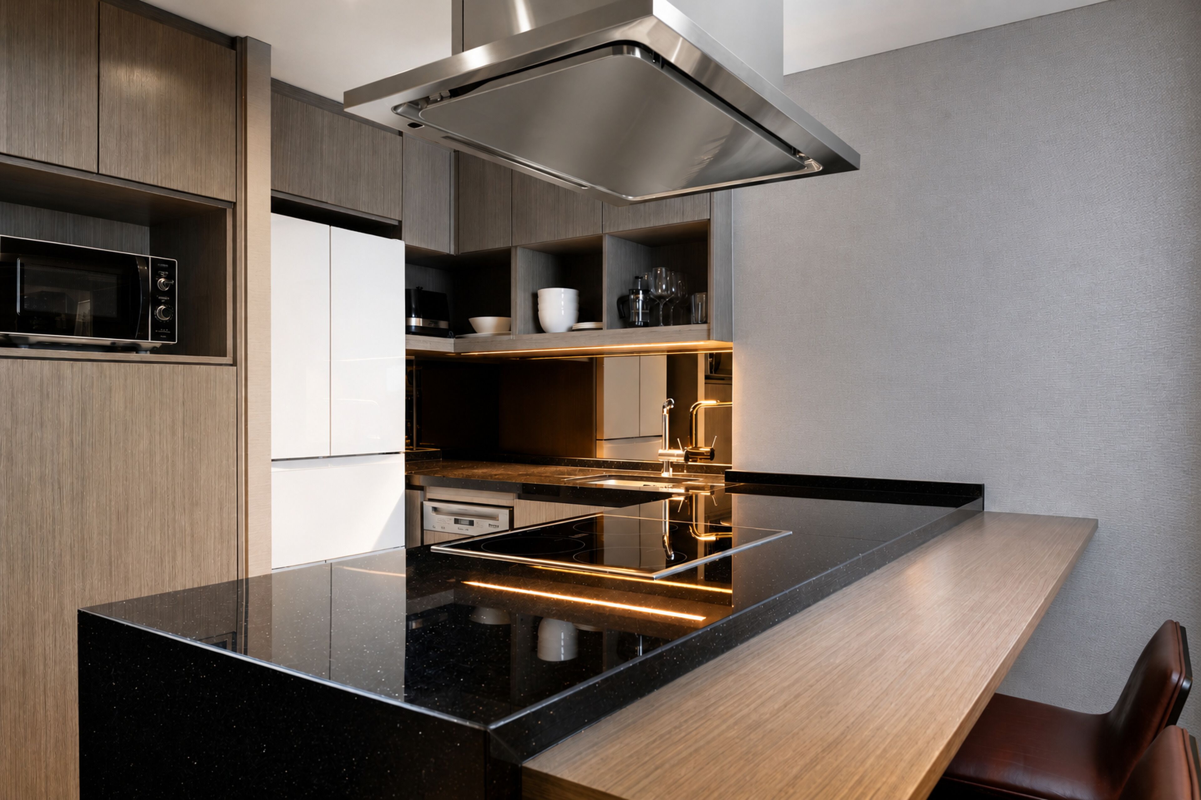 A modern kitchen with a black countertop, stainless steel appliances, and wooden cabinetry.