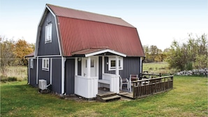 A two-story house with a red roof, a front porch, and a small deck. - 2 bedroom gorgeous home in Jämjö (Jämjö)