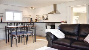 A compact living space with a dining area, kitchenette, and a leather sofa. - 2 bedroom gorgeous home in Jämjö (Jämjö)