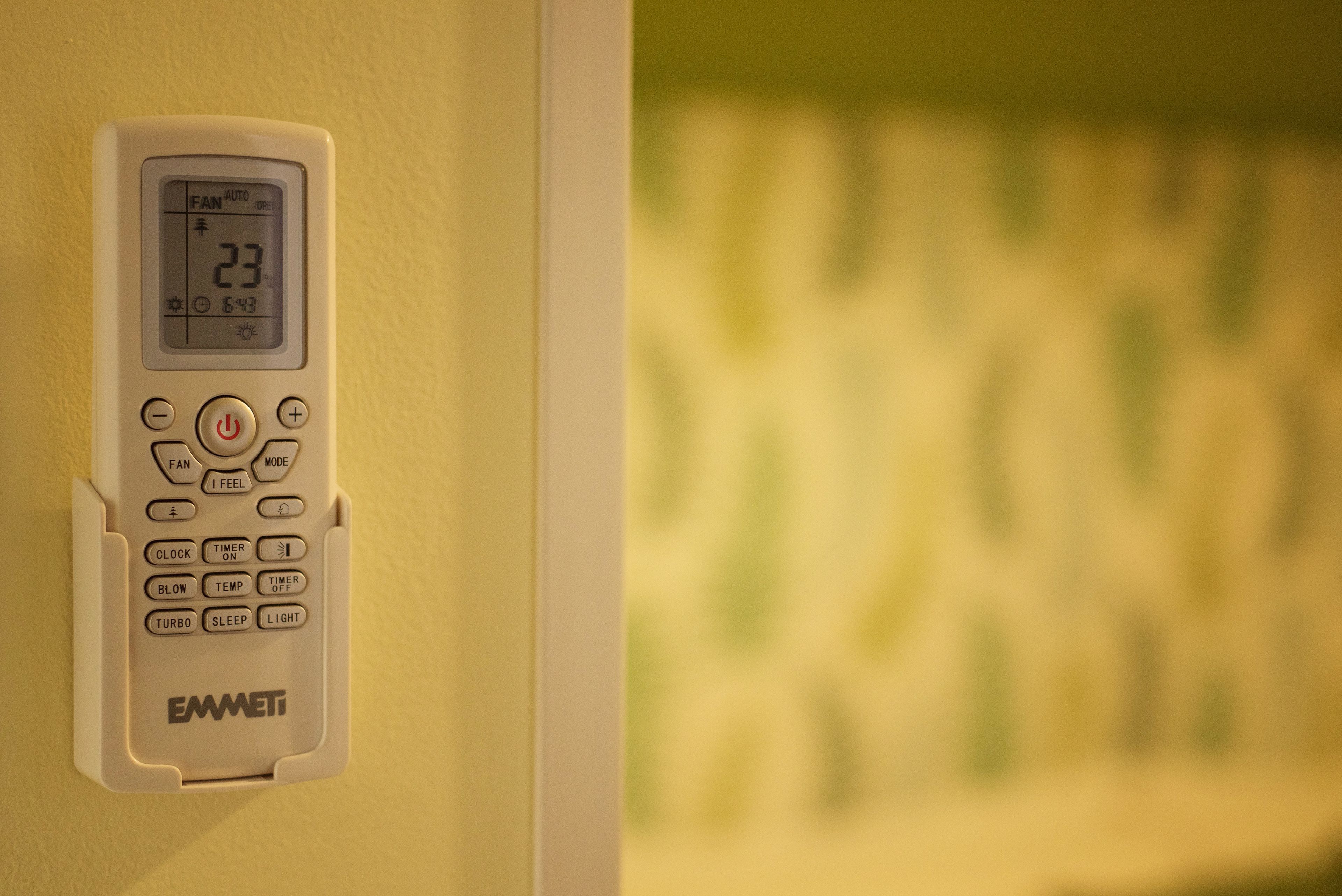 A wall-mounted control panel with various buttons and a digital display.