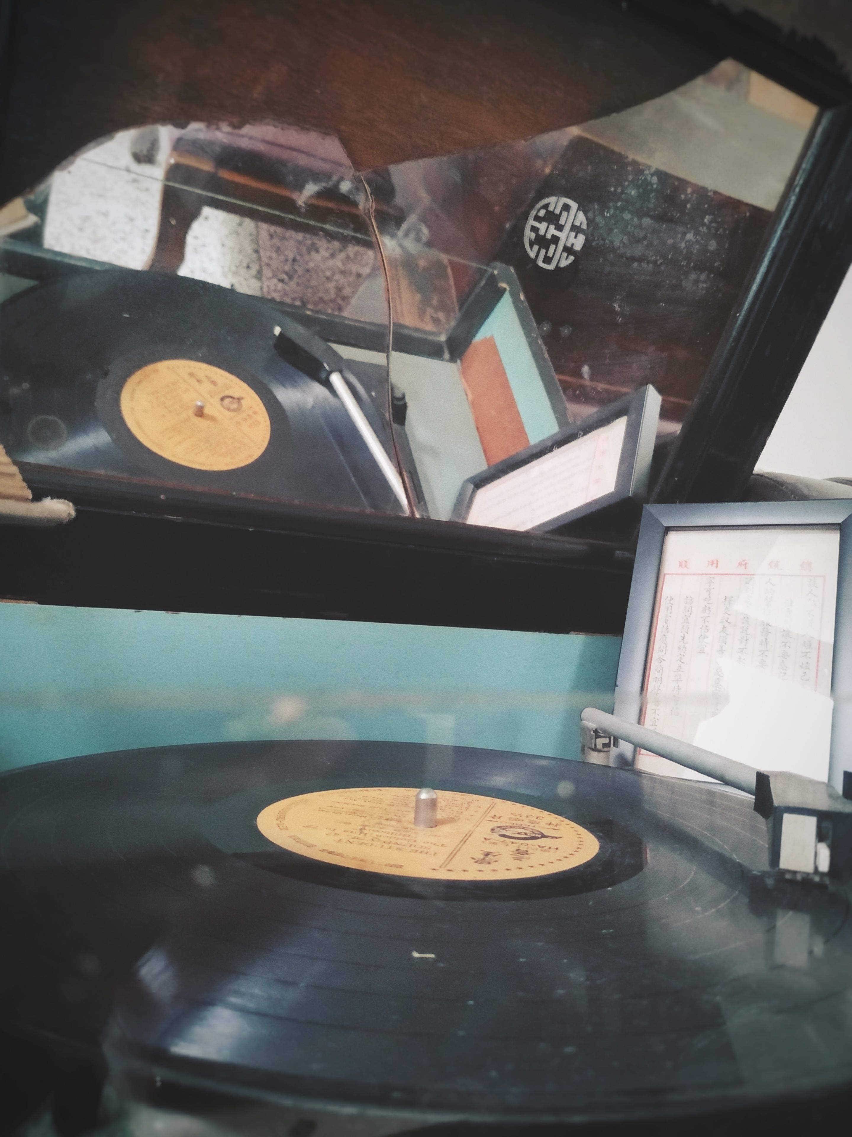A record player with vinyl records and a small display.