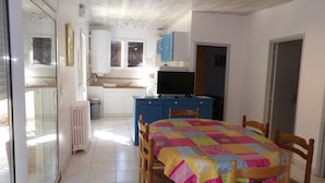 A compact kitchen with white cabinets, a blue countertop, and a black TV. - Gîte for 5 to 7 people in Sarlat. Shared heated pool, nature, wifi (Sarlat la Canéda)