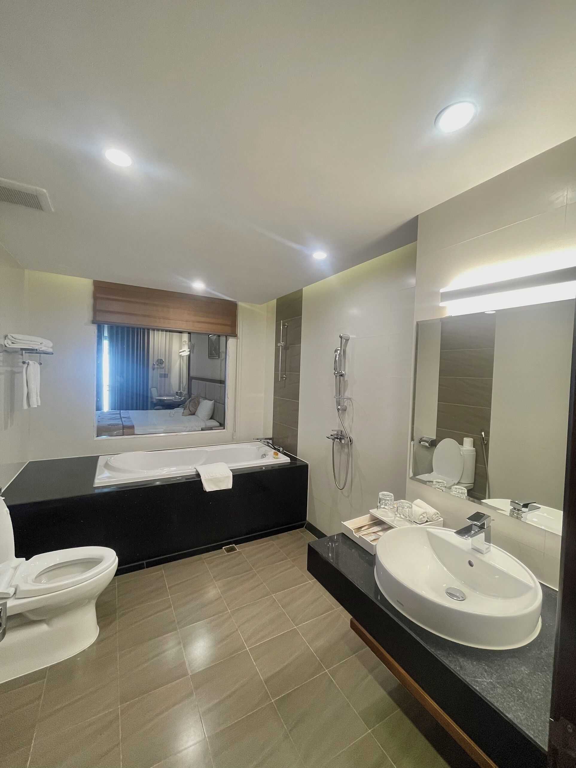 A modern bathroom with a bathtub, toilet, and sink.