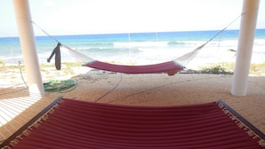 Two hammocks on a sandy beach with a view of the ocean. - RazorBrac SeaEsta - Private Beachfront Home (Cayman Brac)