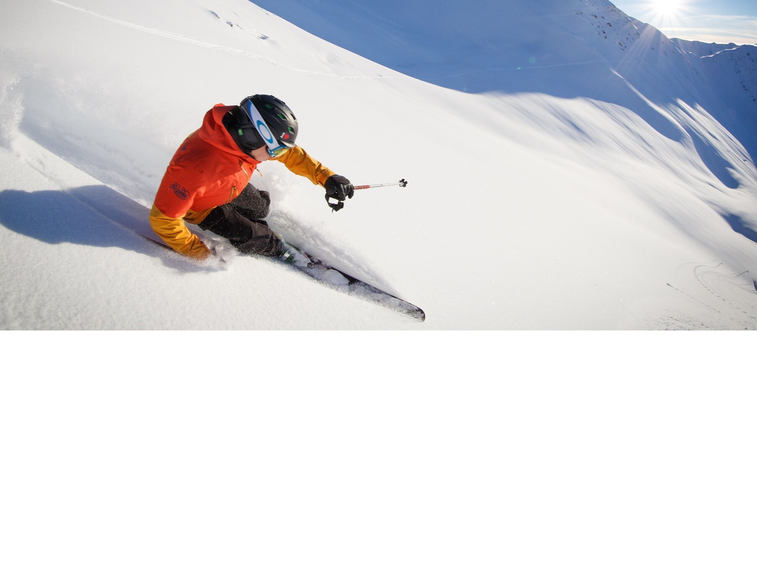 A person skiing down a snowy slope.