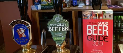 A bar with three beer taps labeled 'Bathams Best Bitter', 'Wye Valley Bitter', and 'Camra's Good Beer Guide 2019'.