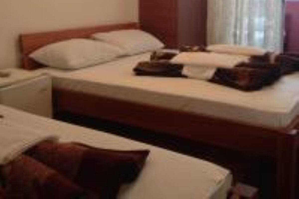 Standard Triple Room | Minibar, laptop workspace, blackout drapes