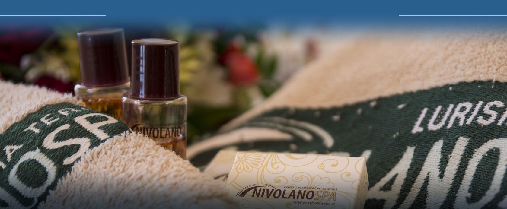 Ein Handtuch mit dem Aufdruck 'NIVOLANO SPA' und eine Flasche 'NIVOLANO'-Produkt.