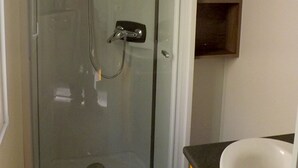 Een douchecabine met glazen wanden en een handdouche.