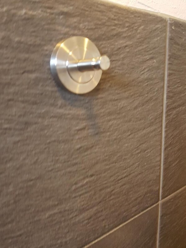 A metallic object on a textured surface, likely a part of a room's interior. - Messe Apartment Hannover (Hannover)