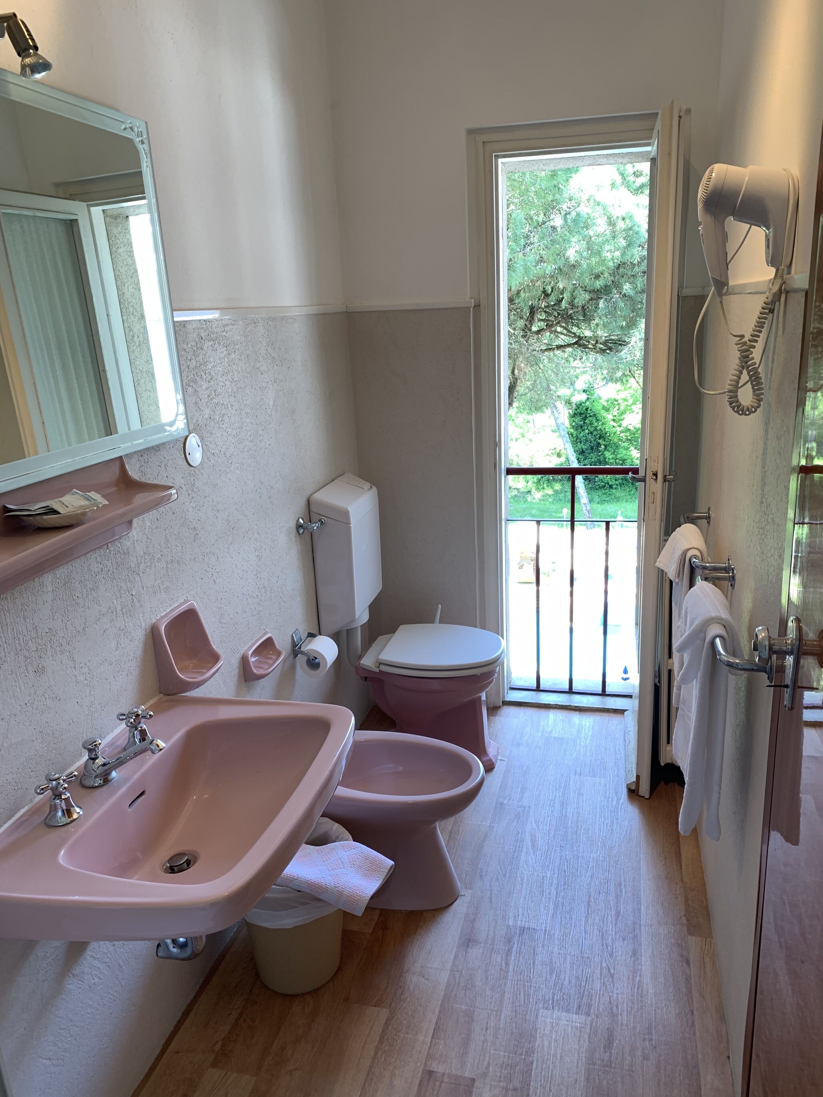 A bathroom with two sinks, a toilet, and a shower.