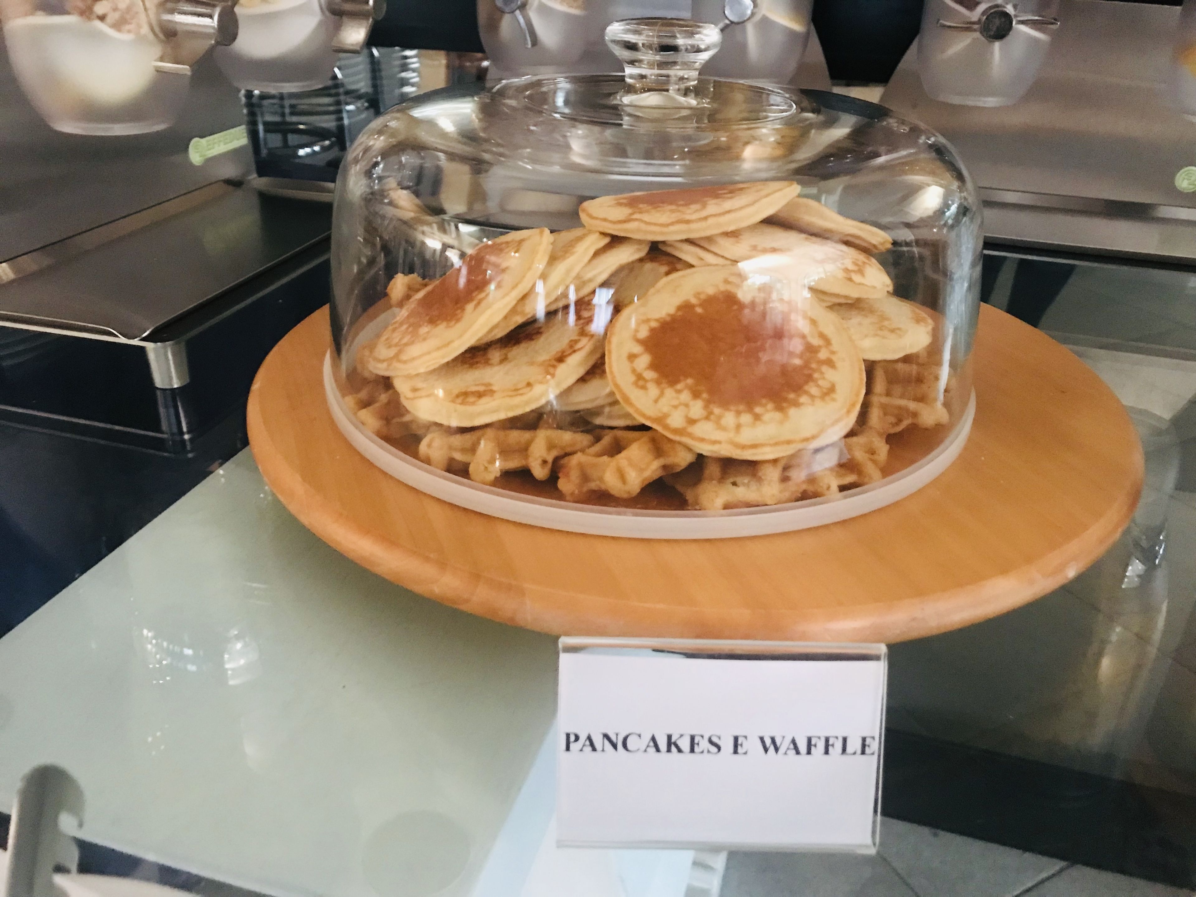 A display case with pancakes and waffles, labeled "Pancakes & Waffles".