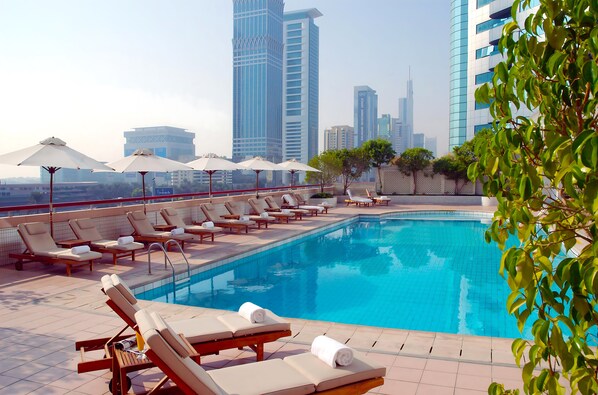 Outdoor pool, open 8:00 AM to 8:00 PM, pool umbrellas