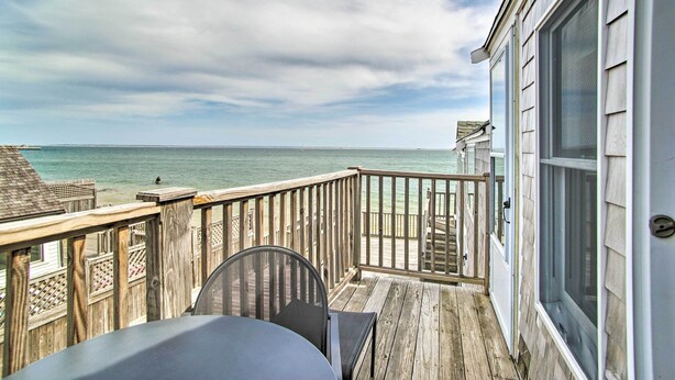 A wooden deck with a view of the ocean. - Harbor Views + Private Deck: Waterfront P-Town Apt (Provincetown)