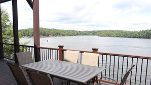A deck with a table and chairs overlooking a lake. - DRAMATIC LAKEFRONT EAGLES LANDING BREATHTAKING VIEWS (Lake Harmony)